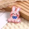 Close-up detail of cute pink cartoon rabbit embroidery patch for clothing DIY decoration. - Pink Little Rabbit