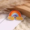 Rainbow embroidered patch detail, colorful DIY clothing accessory close up view for jacket jeans. - Rainbow