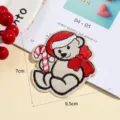 Close-up detail shot of the cute Christmas bear embroidered patch with candy cane and bow. - Style 5 (6.5x7cm)