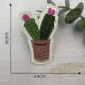 Detailed view of cute cactus embroidered patch with pot and pink flower for clothing decor. - Style 8