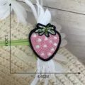 Close-up detail of a cute pink strawberry embroidered patch, fabric clothing accessory. - Style 13