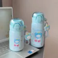 Cute blue insulated water bottle detail showing straw lid, portable strap and lovely bear graphic. - 350ml / Blue
