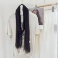 Detail view of a solid color pleated skinny scarf, featuring a lightweight and retro texture. - WR Pleated Deep Purple