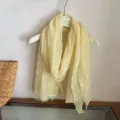 Light yellow crinkled scarf detail showing soft textured fabric and delicate fringe edge. - WR Solid Pleated Texture Yellow