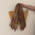 Detail shot of a retro striped linen scarf with frayed edges, soft texture and rustic style. - Light Brown