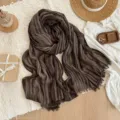 Detailed close-up view of brown striped textured scarf with fringe, ideal for vintage daily wear. - Coffee