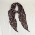 Detailed view of the brown polka dot silk scarf, showing the fine fabric and diagonal tip. - Scattered Star Dots / Coffee