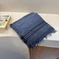 Detailed view of blue striped fringed scarf, soft textured shawl for warm fashion styling. - Dark Blue