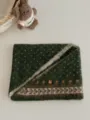 Close-up detail of the dark green Fair Isle knitted scarf, featuring cozy texture and bead flower. - Green