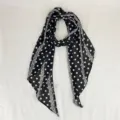 Close-up detail of the black and white polka dot scarf, showing delicate fabric texture. - Polka Dot / Black