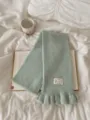 Green knit scarf for women, cozy winter tassel scarf with ruffles and cute label detail. - Light Green