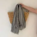 Vue détaillée de l'écharpe rétro à rayures grises avec franges, montrant une texture douce. - Gris clair