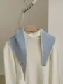 Detailed view of the knitted contrast-edge diamond scarf showing soft texture and cozy fit. - Blue