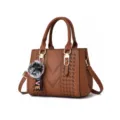 Brown women handbag stylish PU leather shoulder bag with cute pom-pom charm and top handle. - Earthy Yellow
