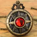Vintage bronze pocket watch detail shot with red gemstone and Roman numeral dial. - Thin Chain / Red Stone - Fine Chain