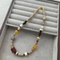Detail view of asymmetric colorful beaded necklace with natural jade, wood and stone beads. - Classic / Colorful
