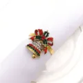 Christmas bell napkin ring detail showing red green rhinestones and bow design on white napkin - 9