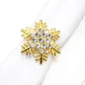 Vista dettagliata di un portatovagliolo dorato a forma di fiocco di neve natalizio strass. - Fiocco di neve / Imitazione Oro