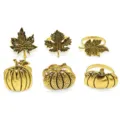 Detailed shot of vintage gold alloy napkin rings featuring autumn leaves and cute pumpkins for table decor. - 3 Maple Leaves & 3 Pumpkins