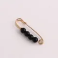 Detail view of gold safety pin brooch with black beads for anti-glare clothing collar fix. - Gold Pin Black Pearl / 3.8CM