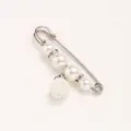 Pearl brooch detail shot showing sparkling rhinestones and elegant pearls on a waist tightening pin. - Silver Pin Hanging Strawberry / 5.8cm