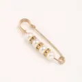 Detail shot of pearl rhinestone safety pin brooch, elegant clothes waist tightening accessory. - 5.50cm / White