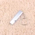 Metal double tube whistle detail shot, portable outdoor survival tool with keychain ring. - Silver