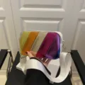Detail view of the colorful metallic striped camera bag showcasing textured multi-color leather. - Rainbow Color-block Metallic Camera Bag / White