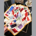 Detailed view of silk square scarf featuring vibrant stamp and ticket illustrations, golden edge. - Colorful Postage Stamp / 68cm