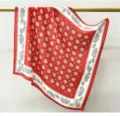 Silk square scarf detail featuring classic red and white paisley print for elegant women. - Red Background Pattern
