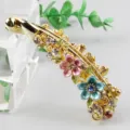 Gold alloy banana hair clip featuring colorful enameled flowers and sparkling rhinestones. - Colorful