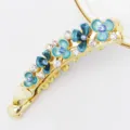 Detailed shot of Korean style floral metal banana clip with blue enamel flowers and sparkling rhinestones. - HB00740 / Blue