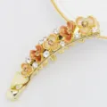 Detail shot of a Korean style flower banana hair clip, gold metal with enamel and rhinestones. - HB00740 / Coffee