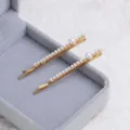 Elegant gold-plated hair clips featuring stylish faux pearl embellishments for women. - RY09053