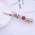 Gold alloy hair clip with pink enamel flowers and sparkly rhinestones for elegant hairstyles. - H009310 Pink
