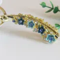 Vintage enamel floral banana hair clip with rhinestones, elegant retro metal hair accessory. - Blue