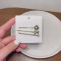 Ensemble de pinces à cheveux dorées avec zircons étincelants, nœud élégant et camée. - RY08969