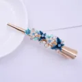 Blue rhinestone enamel flower metal hair clip, elegant fashion accessory for women. - Blue
