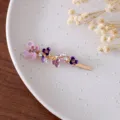 Purple enamel flower hair clip featuring sparkling rhinestones and elegant gold finish. - RY07619(Purple)