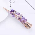 Elegant metal hair clip featuring purple enamel flowers and sparkling rhinestones for women. - Purple