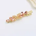 Gold-tone metal hair clip decorated with sparkling pink rhinestones, elegant duckbill design for women. - Champagne (H010038)