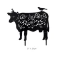 Black acrylic cow yard art detail showing hollow floral silhouette and bird design on stake. - Cow Silhouette / Black