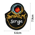 Detailed shot of a black embroidered cloth patch featuring stylish text and astronaut pattern. - DW9082-2