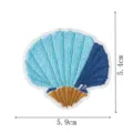 Blue and gold embroidered seashell patch detail showing fine stitching texture and size info. - Seashell (DW9204-11)