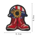 Detailed view of the embroidered patch showing fine stitching, sunflower and boot design. - Helmet and Boots