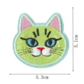 Detailed view of cute green cat embroidery patch with blue eyes, perfect for DIY clothes repair. - Style 2