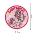 Retro aesthetic Sagittarius zodiac embroidered patch detail with pink background and clear size. - Sagittarius