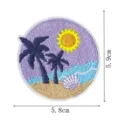 Close-up detail of a round tropical beach embroidery patch featuring palm trees and a seashell. - Circular Tropical Beach