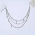 Detail shot of multi-layer silver metal waist chain with punk spike pendants for street style. - Style 11
