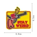 Detail shot of the cartoon western revolver and lightning embroidered patch with stay weird text. - Revolver Style (DW9804-3)